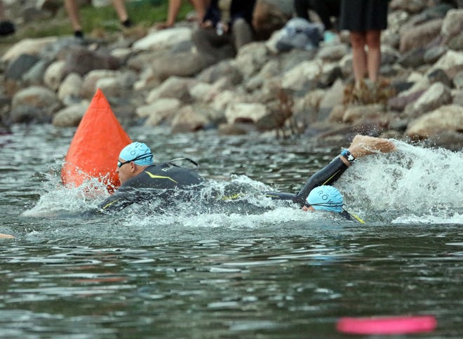 Competitors swim during the Ironman North American Championship 140.6-mile Des Moines Triathlon as athletes compete in a 2.4-mile swim at Gray’s Lake, 112-mile bike race, and a 26.2-mile run in Des Moines on Sunday, June 12, 2022. This regional competition will offer qualifying slots to the 2022 Ironman World Championship in Kailua-Kona, Hawaii in early October 2022.