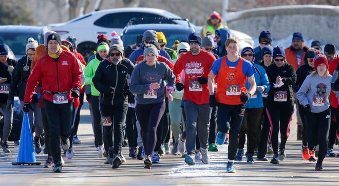 Runners start the 5K Run/Walk & Kids Fun Run as part of the Sturgeon Spectacular at Lakeside Park, Saturday, February 11, 2023, in Fond du Lac, Wis.