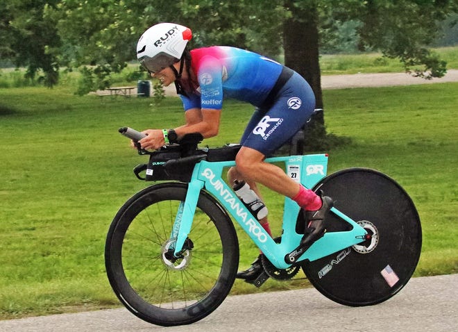 Kelly Fillnow of the United States rides through Water Works Park during the Ironman North American Championship 140.6-mile Des Moines Triathlon as athletes compete in a 2.4-mile swim at Gray’s Lake, 112-mile bike race, and a 26.2-mile run in Des Moines on Sunday, June 12, 2022. This regional competition will offer qualifying slots to the 2022 Ironman World Championship in Kailua-Kona, Hawaii in early October 2022.