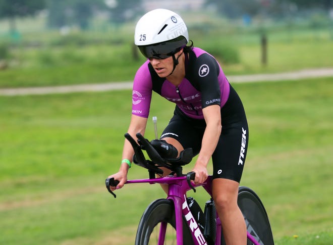 Skye Moench of the United States rides through Water Works Park during the Ironman North American Championship 140.6-mile Des Moines Triathlon as athletes compete in a 2.4-mile swim at Gray’s Lake, 112-mile bike race, and a 26.2-mile run in the Des Moines metro on Sunday, June 12, 2022. This regional competition offered qualifying slots to the 2022 Ironman World Championship in Kailua-Kona, Hawaii, in early October 2022.