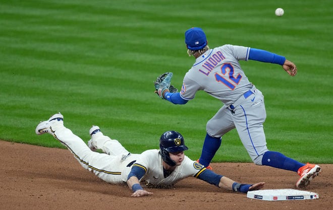 Milwaukee Brewers left fielder Christian Yelich (22) beats a throw to New York Mets shortstop Francisco Lindor (12) to steal second base during the fifth inning of their game Monday, April 3, 2023 at American Family Field in Milwaukee, Wis.



Mark Hoffman/Milwaukee Journal Sentinel