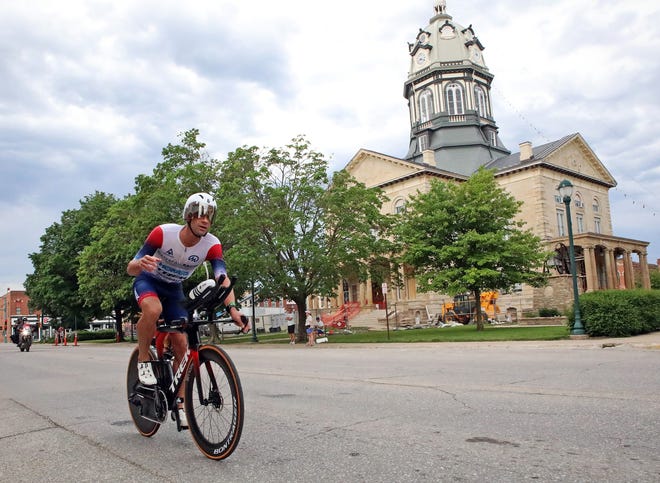 Tim O'Donnell of the United States races by the Madison County Courthouse on John Wayne Drive in Winterset during the Ironman North American Championship 140.6-mile Des Moines Triathlon as athletes compete in a 2.4-mile swim at Gray’s Lake, 112-mile bike race, and a 26.2-mile run in Des Moines on Sunday, June 12, 2022. This regional competition will offer qualifying slots to the 2022 Ironman World Championship in Kailua-Kona, Hawaii in early October 2022.