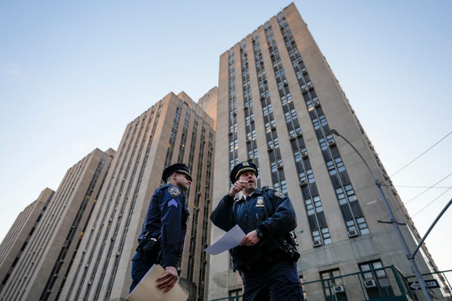 Police officers secure the perimeter outside Manhattan Criminal Court, Tuesday, April 4, 2023, in New York.