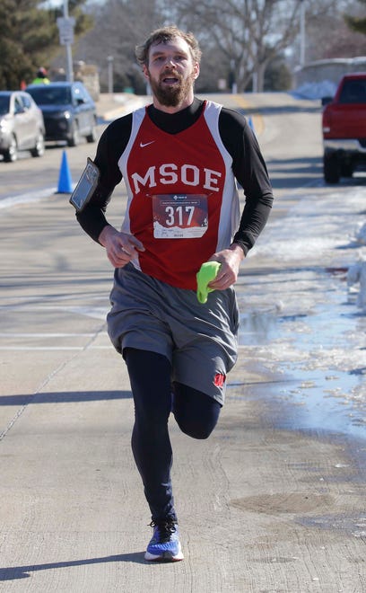 Robert Coehoorn, of Brandon, Wis., arrives first for the 5K Run/Walk & Kids Fun Run at Lakeside Park, Saturday, February 11, 2023, in Fond du Lac, Wis.