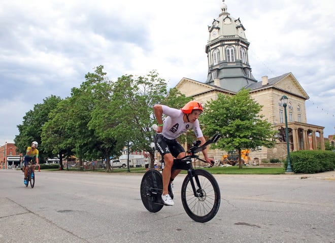 Jesper Svensson of Sweden races by the Madison County Courthouse on John Wayne Drive in Winterset during the Ironman North American Championship 140.6-mile Des Moines Triathlon as athletes compete in a 2.4-mile swim at Gray’s Lake, 112-mile bike race, and a 26.2-mile run in Des Moines on Sunday, June 12, 2022. This regional competition will offer qualifying slots to the 2022 Ironman World Championship in Kailua-Kona, Hawaii in early October 2022.