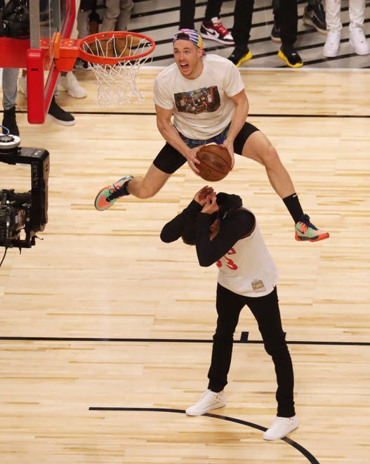 Milwaukee Bucks shooting guard Pat Connaughton dunks over Milwaukee Brewers Christian Yelich in the slam dunk contest during NBA All Star Saturday Night at United Center. Mike De Sisti / The Milwaukee Journal Sentinel ORG XMIT: USATSI-425821