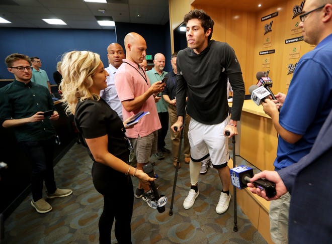 Milwaukee Brewers Christian Yelich makes his way with scratches as he enters the interview room where he talked to the media at Miller Park in Milwaukee on Monday, Sept. 16, 2019. It was the first time Yelich spoke publicly about his injury that occurred on Sept. 10 when he fouled a pitch off his right knee that broke his kneecap during a game against the Miami Marlins, ending his 2019 season. - Photo by Mike De Sisti/Milwaukee Journal Sentinel ORG XMIT: DBY1