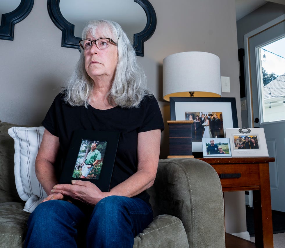 Deborah Hoffmann holds a photo of her ex-husband, Dean Hoffmann, on Sept. 9 in Cedarburg.