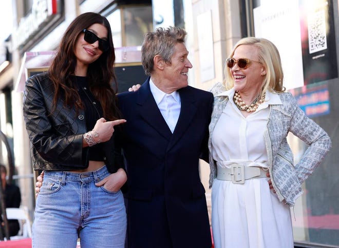 Actress and model Camila Morrone (left) and actress Patricia Arquette (right) pose with actor Willem Dafoe during the ceremony honoring him with a Hollywood Walk of Fame star in Hollywood, California, on Jan. 8, 2024.