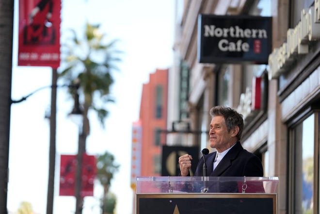 Willem Dafoe gestures as he speaks at a ceremony honoring him with a star on the Hollywood Walk of Fame, Monday, Jan. 8, 2024, in Los Angeles.