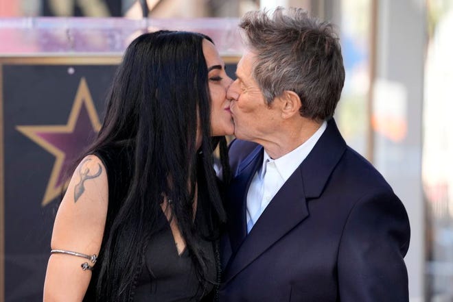 Willem Dafoe, right, kisses his wife, Giada Colagrande, at a ceremony honoring Dafoe with a star on the Hollywood Walk of Fame, Monday, Jan. 8, 2024, in Los Angeles.