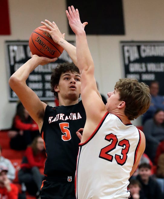 Kaukauna High School's Andrew Jensen (5) puts up a shot against Kimberly High School's Landon VanOfferen (23) during their boys basketball game Wednesday, January 10, 2024, in Kimberly, Wisconsin. Kimberly won 73-72 in double overtime.