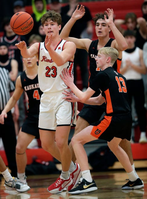 Kimberly High School's Landon VanOfferen (23) passes the ball against Kaukauna High School's Jonah Roehrig (13) during their boys basketball game Wednesday, January 10, 2024, in Kimberly, Wisconsin. Kimberly won 73-72 in double overtime.