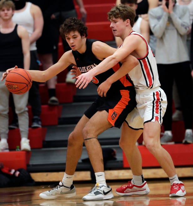 Kaukauna High School's Andrew Jensen (5) tries to get past Kimberly High School's Landon VanOfferen (23) during their boys basketball game Wednesday, January 10, 2024, in Kimberly, Wisconsin. Kimberly won 73-72 in double overtime.