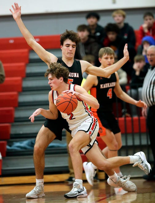 Kaukauna High School's Jon O'Neill (15) defends against Kimberly High School's Mikey Wildes (2) during their boys basketball game Wednesday, January 10, 2024, in Kimberly, Wisconsin. Kimberly won 73-72 in double overtime.