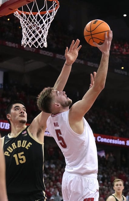 Wisconsin forward Tyler Wahl (5) scores on Purdue center Zach Edey (15) during the second half of their game Sunday, February 4, 2024 at the Kohl Center in Madison, Wisconsin. Purdue beat Wisconsin 75-69.
