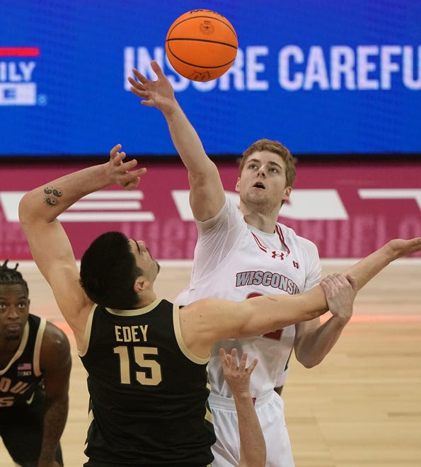 Wisconsin's Steven Crowl (22) wins the opening tipoff against Purdue center Zach Edey (15) during the first half of their game Sunday, February 4, 2024 at the Kohl Center in Madison, Wisconsin.