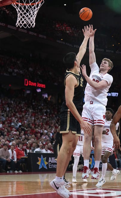 Wisconsin forward Steven Crowl (22) scores on Purdue center Zach Edey (15) during the second half of their game Sunday, February 4, 2024 at the Kohl Center in Madison, Wisconsin. Purdue beat Wisconsin 75-69.