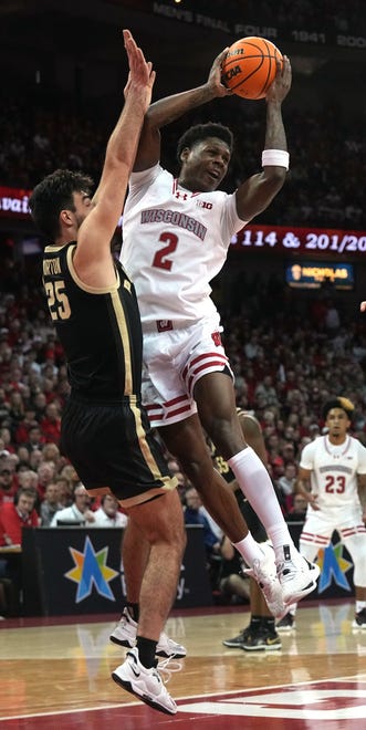 Wisconsin guard AJ Storr (2) passes the ball while being guarded by guard Ethan Morton (25) during the second half of their game Sunday, February 4, 2024 at the Kohl Center in Madison, Wisconsin. Purdue beat Wisconsin 75-69.