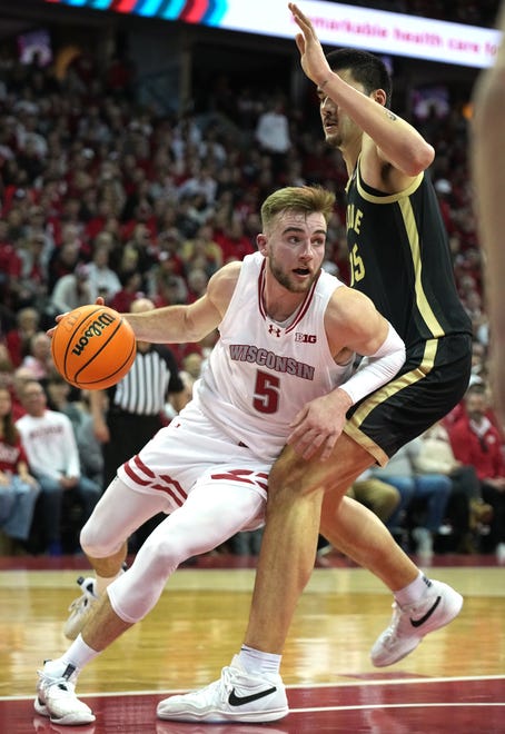 Wisconsin forward Tyler Wahl (5) drives around Purdue center Zach Edey (15) during the second half of their game Sunday, February 4, 2024 at the Kohl Center in Madison, Wisconsin. Purdue beat Wisconsin 75-69.