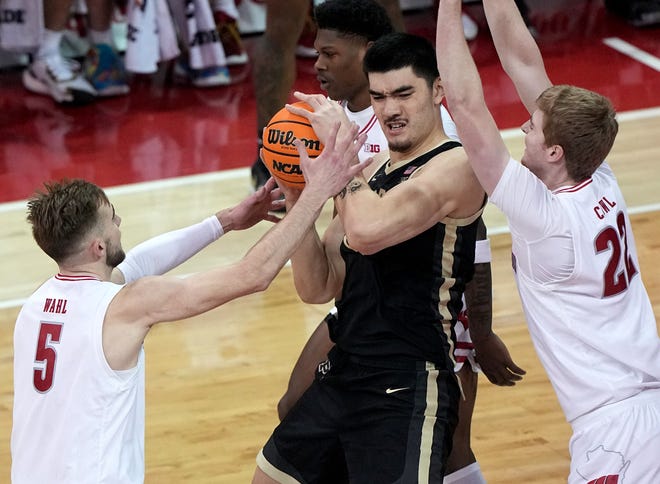 Purdue’s Zach Edey (15) is swarmed by Wisconsin forward Tyler Wahl (5) and forward Steven Crowl (22) during the first half of their game Sunday, February 4, 2024 at the Kohl Center in Madison, Wisconsin.