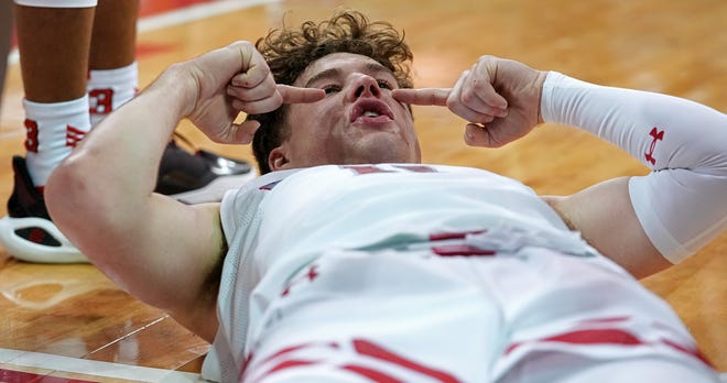 Wisconsin guard Max Klesmit (11) takes moment before getting up after getting hit in the face during the second half of their game Sunday, February 4, 2024 at the Kohl Center in Madison, Wisconsin. Purdue beat Wisconsin 75-69.