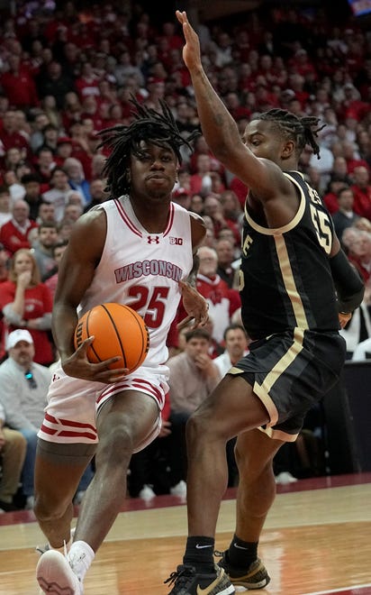 Wisconsin guard John Blackwell (25) drives past Purdue guard Lance Jones (55) during the second half of their game Sunday, February 4, 2024 at the Kohl Center in Madison, Wisconsin. Purdue beat Wisconsin 75-69.