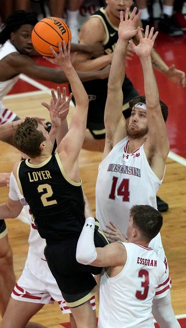 Wisconsin forward Carter Gilmore (14) fouls Purdue guard Fletcher Loyer (2) during the first half of their game Sunday, February 4, 2024 at the Kohl Center in Madison, Wisconsin.\
