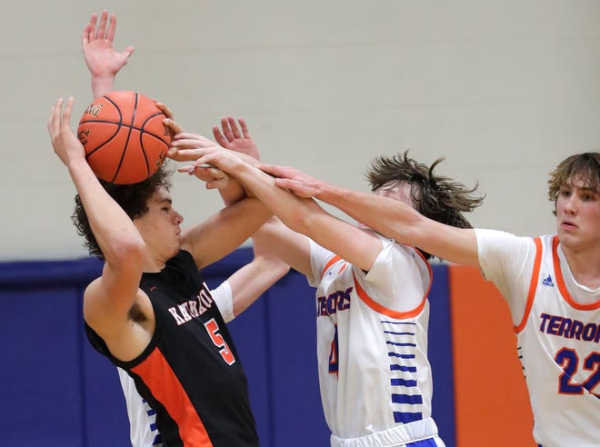 Kaukauna High School's Andrew Jensen (5) is under heavy pressure from Appleton West High School's Kyle Bennett (4) and Conner Cotton (22) during their boys basketball game Friday, February 2, 2024, in Appleton, Wisconsin. Kaukauna won 95-48.