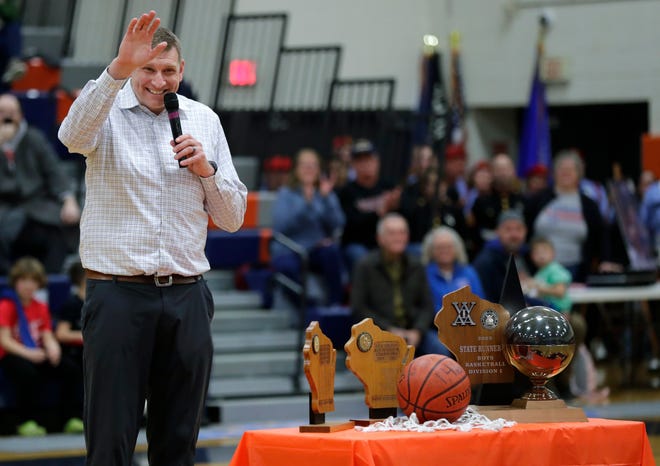 Appleton West great Brian Butch waves to his family Friday, February 2, 2024, in Appleton, Wisconsin. Butch had his No. 42 jersey retired by the school prior to Friday's game against Kaukauna. Butch was a two-time Associated Press state player of the year, the 2003 Wisconsin Mr. Basketball winner and a McDonald's All-American during his final season with the Terrors.