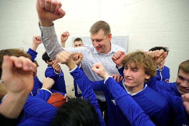 Appleton West great Brian Butch breaks things down with varsity players after giving them a pep talk Friday, February 2, 2024, in Appleton, Wisconsin. Butch had his No. 42 jersey retired by the school prior to Friday's game against Kaukauna. Butch was a two-time Associated Press state player of the year, the 2003 Wisconsin Mr. Basketball winner and a McDonald's All-American during his final season with the Terrors.