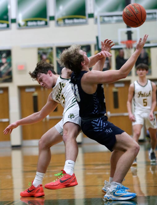 Freedom High School's Matt Eberhardt (3) collides with Little Chute High School's Cooper Effa (23) as they go for the ball during their boys basketball game Thursday, February 1, 2024, in Freedom, Wisconsin. Freedom won 54-47.