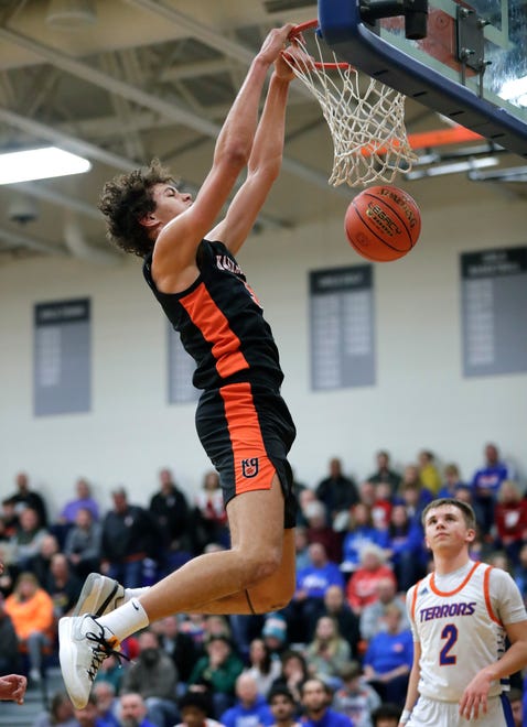 Kaukauna High School's Andrew Jensen (5) dunks against Appleton West High School's Braylon Ise (2) during their boys basketball game Friday, February 2, 2024, in Appleton, Wisconsin. Kaukauna won 95-48.