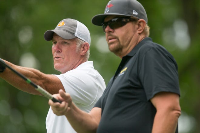 Former Green Bay Packers quarterback Brett Favre, left, and singer Toby Keith plan out their tee off during the AmFam Champ Celebrity Foursome at University Ridge Golf Course in Madison on June 22, 2019.