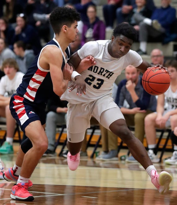 Appleton North High School's Abraham Tomori (23) against Appleton East High School's Grayson Kasmarek (0) during their boys basketball game on Tuesday, February 6, 2024 at Appleton North High School in Appleton, Wis. East defeated North 58-44.
Wm. Glasheen USA TODAY NETWORK-Wisconsin