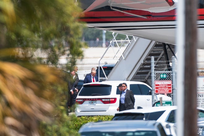 Former President Donald Trump ascends the stairs of his jet on April 3, 2023, in West Palm Beach, Fla.