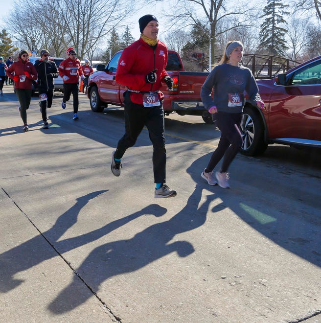 Runners compete with their shadows during the 5K Run/Walk & Kids Fun Run at Lakeside Park, Saturday, February 11, 2023, in Fond du Lac, Wis.