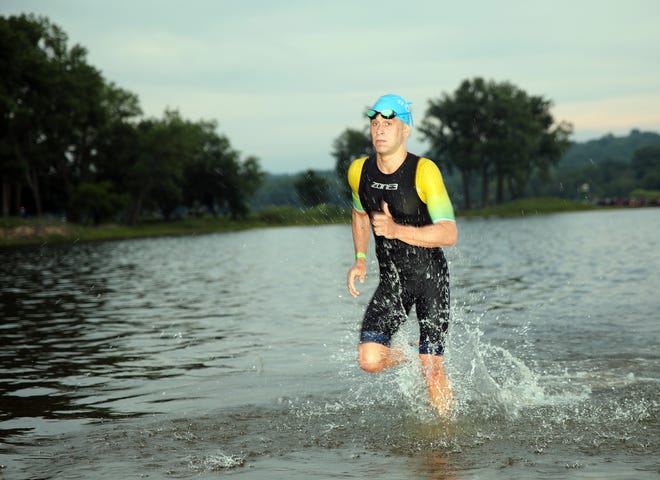 Andre Lopes of Brazil exits the water during the Ironman North American Championship 140.6-mile Des Moines Triathlon as athletes compete in a 2.4-mile swim at Gray’s Lake, 112-mile bike race, and a 26.2-mile run in Des Moines on Sunday, June 12, 2022. This regional competition will offer qualifying slots to the 2022 Ironman World Championship in Kailua-Kona, Hawaii in early October 2022.