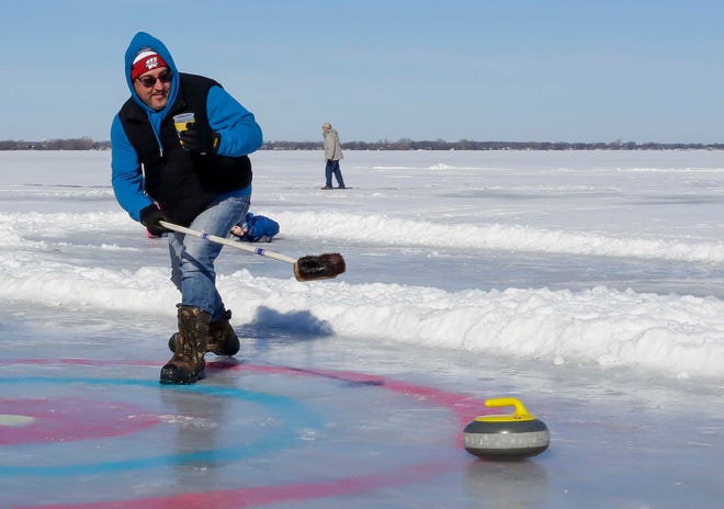 Brian Schmitz, of Fond du Lac, observes the stone he releases while curling, Saturday, February 11, 2023, in Fond du Lac, Wis.