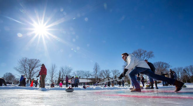 Erik Johnson, of Fond du Lac, releases the stone while curling on Lake Winnebago during the Sturgeon Spectacular, Saturday, February 11, 2023, in Fond du Lac, Wis.