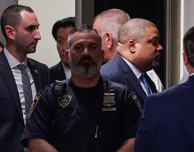 Manhattan District Attorney Alvin Bragg, far right, passes through a hallway outside the courtroom, Tuesday, April 4, 2023, in New York. Trump is set to appear in a New York City courtroom on charges related to falsifying business records in a hush money investigation, the first president ever to be charged with a crime.