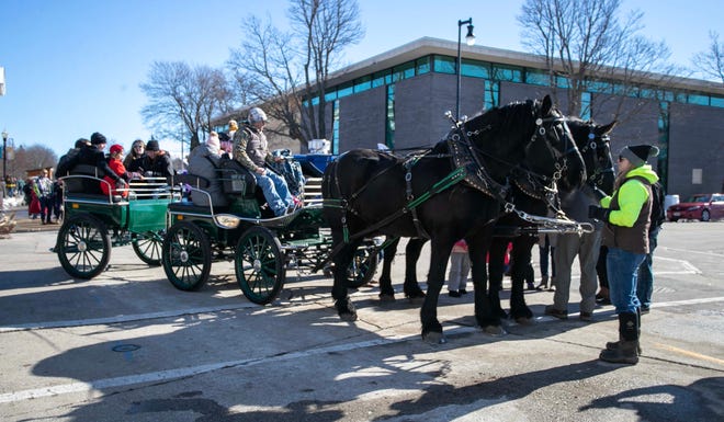 A Breezy Hill Campground horse-drawn carriage waits for passengers during the Sturgeon Spectacular, Saturday, February 11, 2023, in Fond du Lac, Wis.