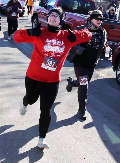 A runner gives a thumbs up during the 5K Run/Walk & Kids Fun Run at Lakeside Park during the Sturgeon Spectacular, Saturday, February 11, 2023, in Fond du Lac, Wis.