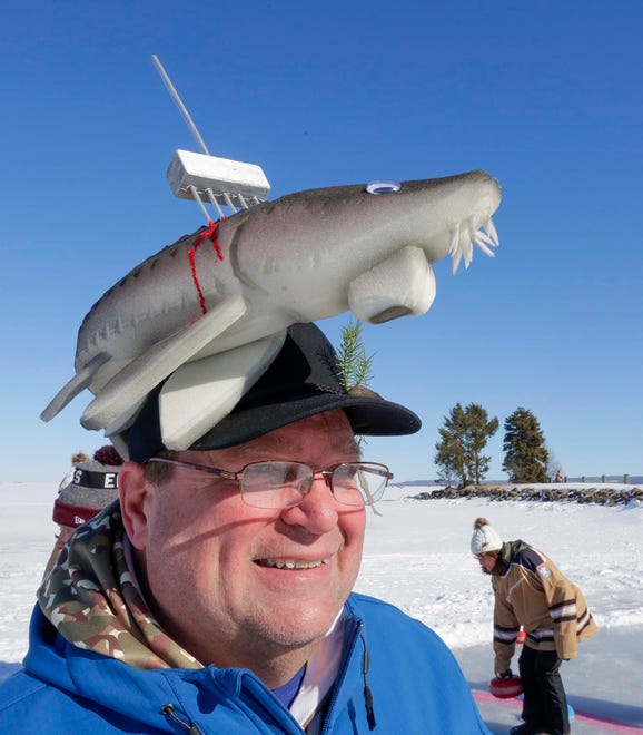 Dave Koenef, of Fond du Lac, sports a Sturgeon hat while having fun at curling during the Sturgeon Spectacular, Saturday, February 11, 2023, in Fond du Lac, Wis.