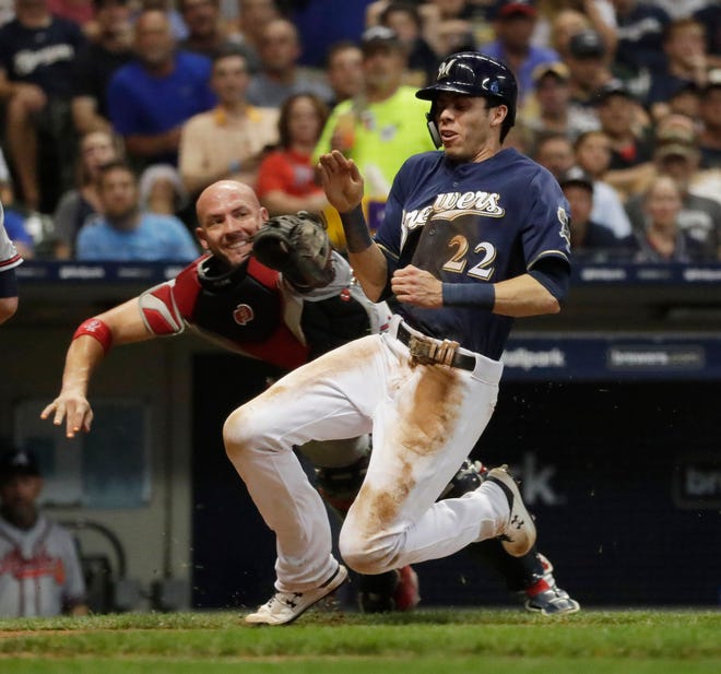 Milwaukee Brewers right fielder Christian Yelich (22) steals home on a wild pitch eluding Atlanta Braves catcher Tyler Flowers (25) to score  during the Milwaukee Brewers vs, Atlanta Braves at Miller Park, Tuesday, July 16, 2019

Rick Wood/Milwaukee Journal Sentinel  ORG XMIT: